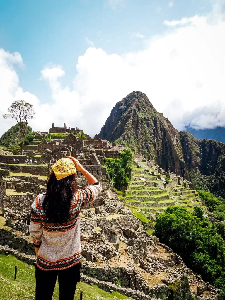 A female is looking at Machu Picchu in Peru