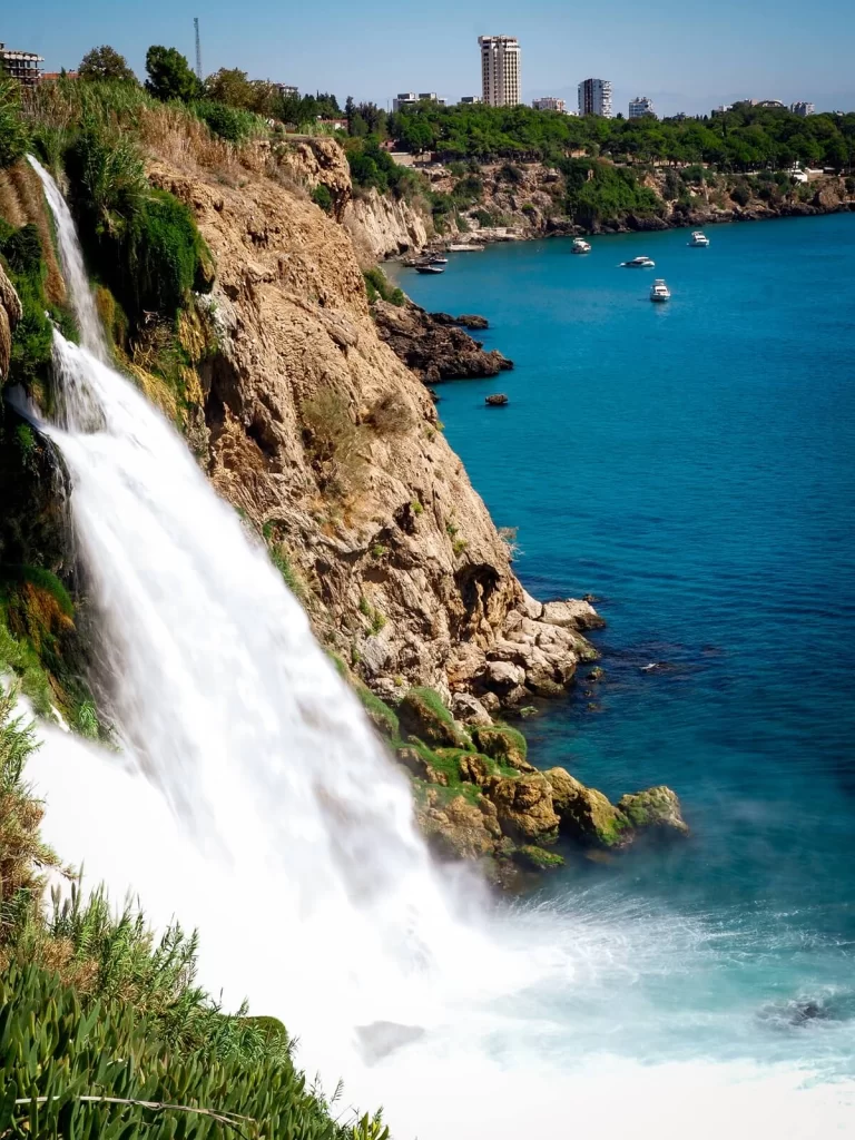 Waterfall cascading into the sea from a cliffside