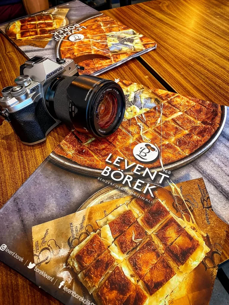 A table with a Borek menu and a camera on it