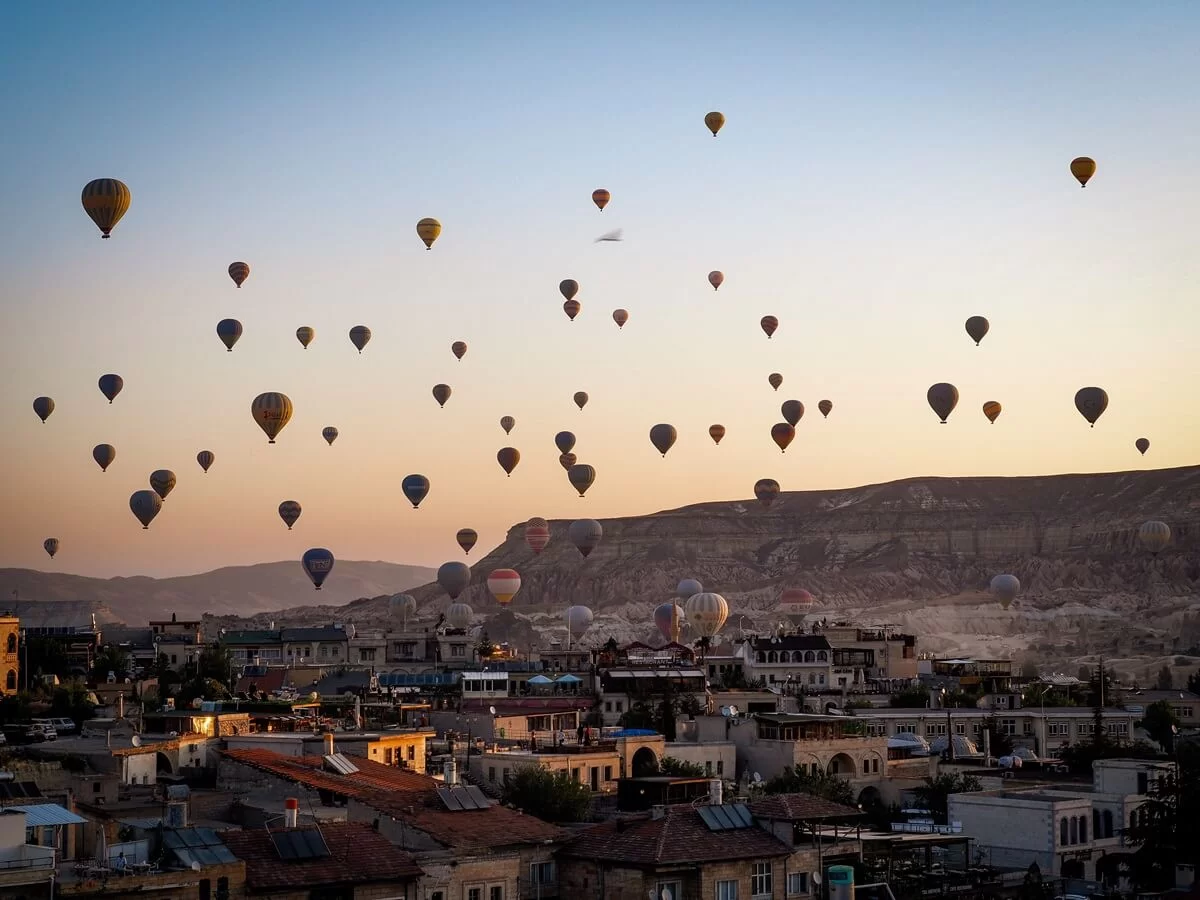 A sky filled with hot air balloons during sunrise in Cappadocia Turkey