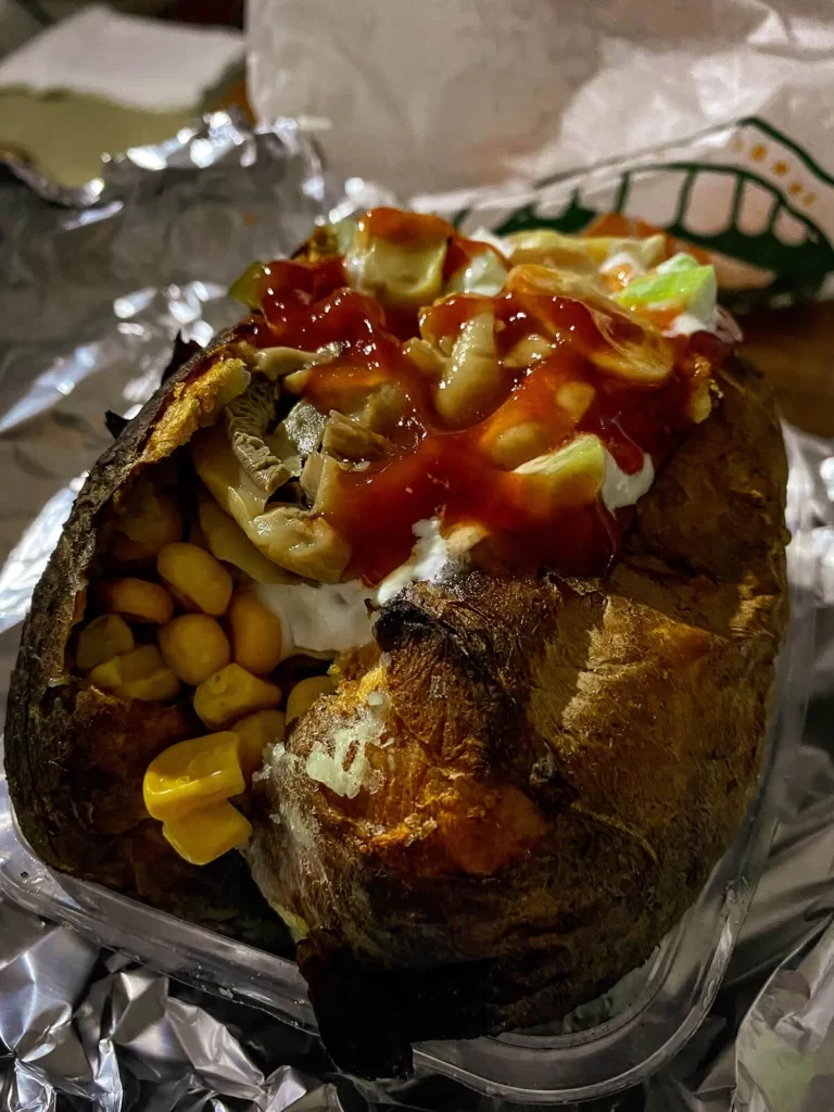 A jacket or baked potato with a variety of filling such as sweet corn, cheese and red sauce