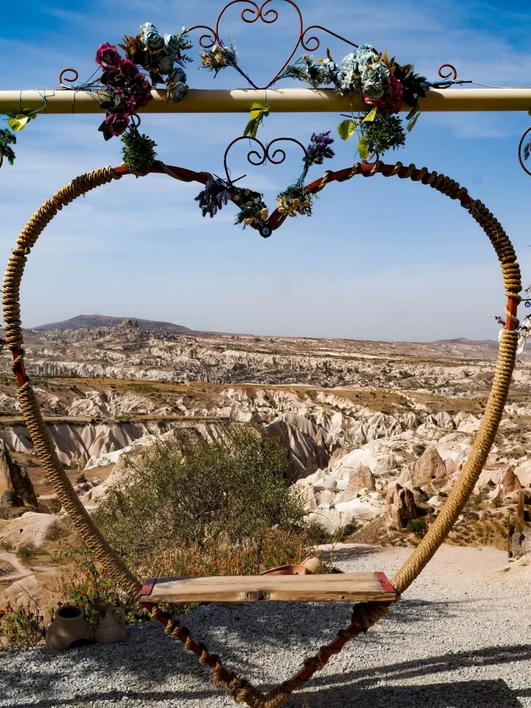 A heart-shape bench overlooking a valley with rock formations