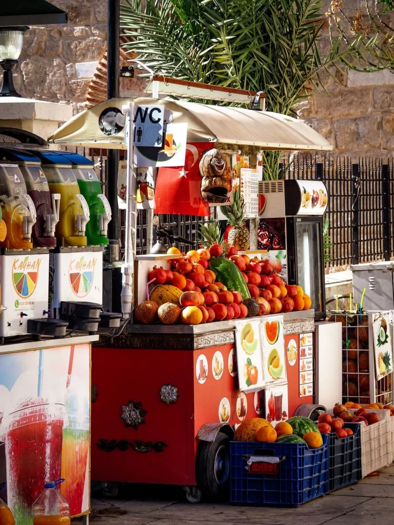 Street food stall selling various fruit and juices in Turkey