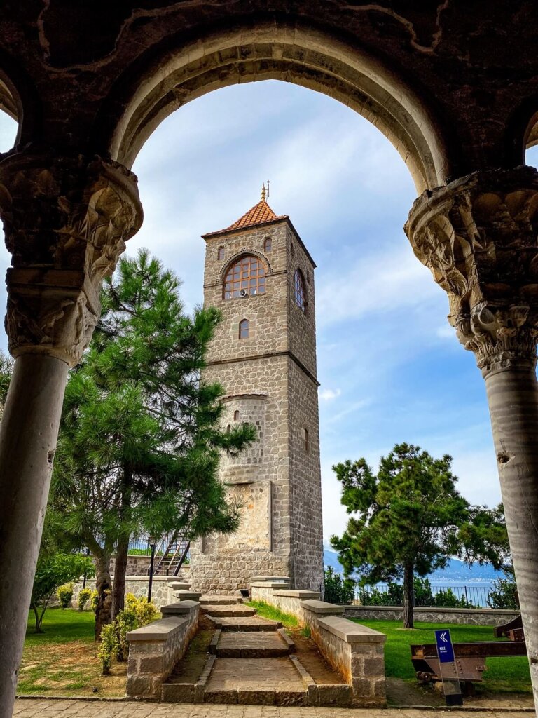 A view of a small tower through an arch in Trabzon Turkey