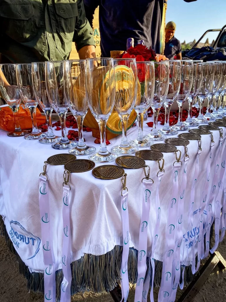 champagne glasses and medals on a table