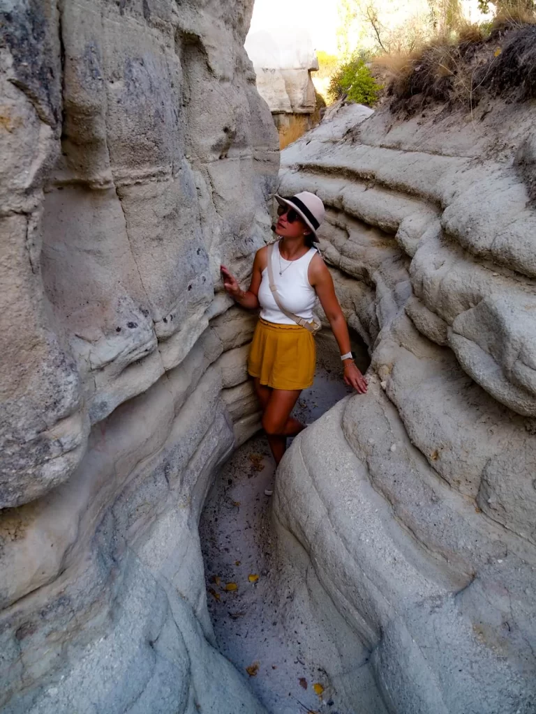 Female traveller is walking through a very narrow gully in Cappadocia