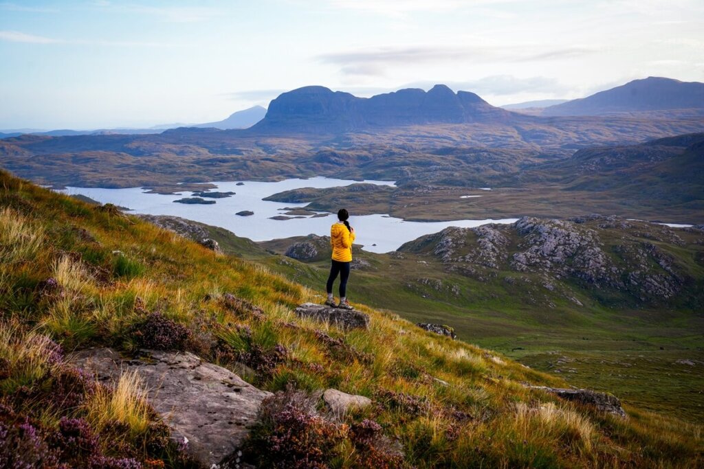 Female hiker is hiking up Stac Pollaidh in Scotland