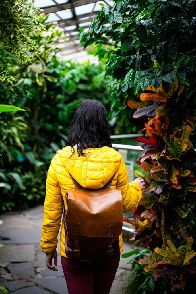 A female is walking through a botanic garden in Inverness