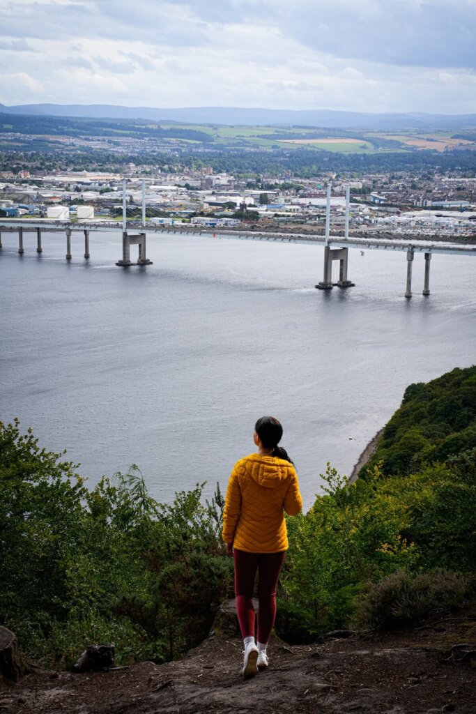 A female is standing at a viewpoint of Kessock Bridge in Inverness
