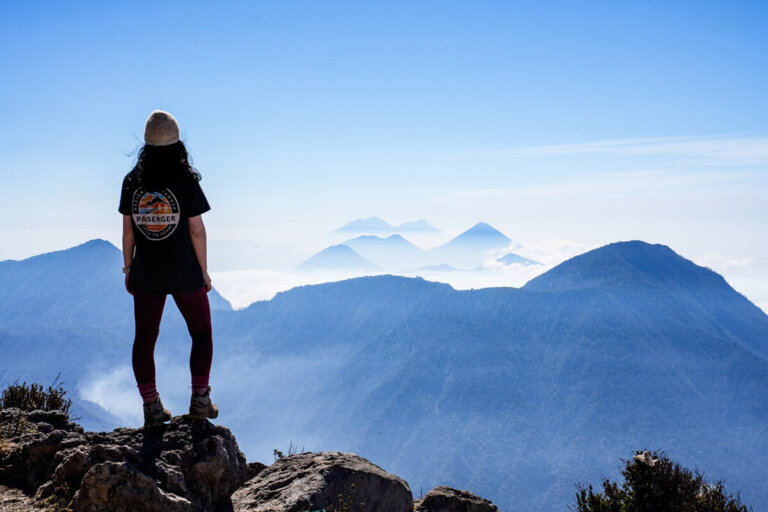 Female hiker is standing on top of Volcan Santa Maria in Xela Guatemala