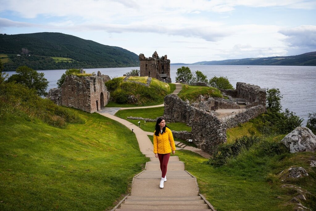 A female is walking up some stairs at Urquhart castle near Inverness Scotland