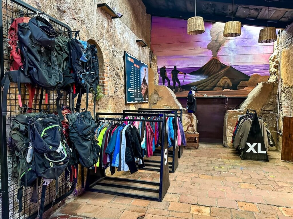 Backpacks and hiking clothes in a tour office in Antigua