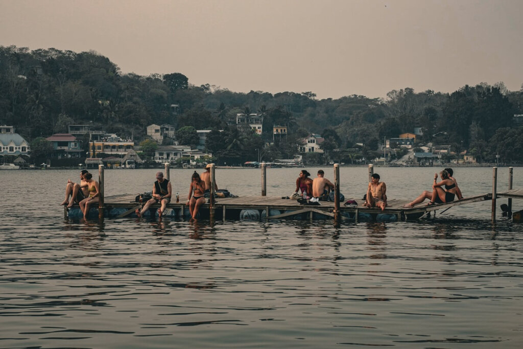 People are sitting on a jetty in Flores Guatemala