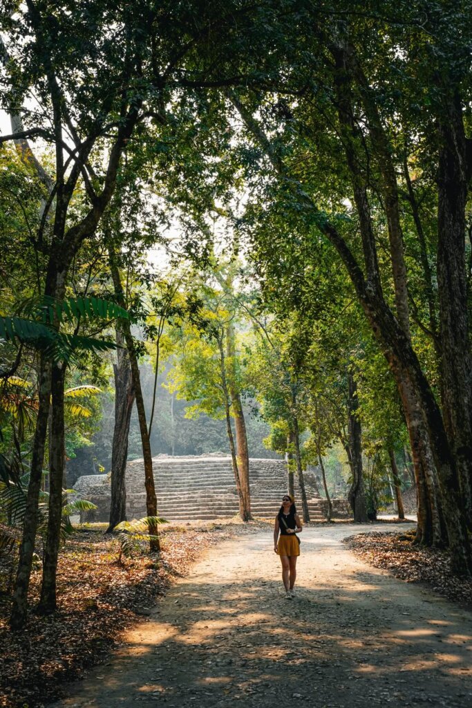 Female is walking along the path in Yaxha