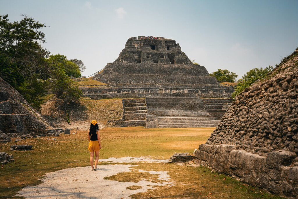 A girl is walking in front of a temple in Xuanantunich Maya Site near San Ignacio