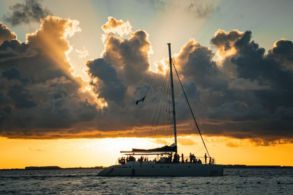 boat sailing around Isla Mujeres during sunset