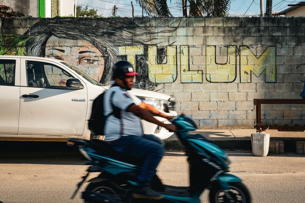 A man on a scooter in Tulum Mexico