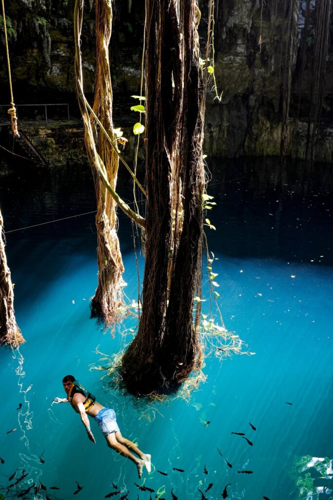 Male is swimming in Cenote Oxman near Valladolid Mexico