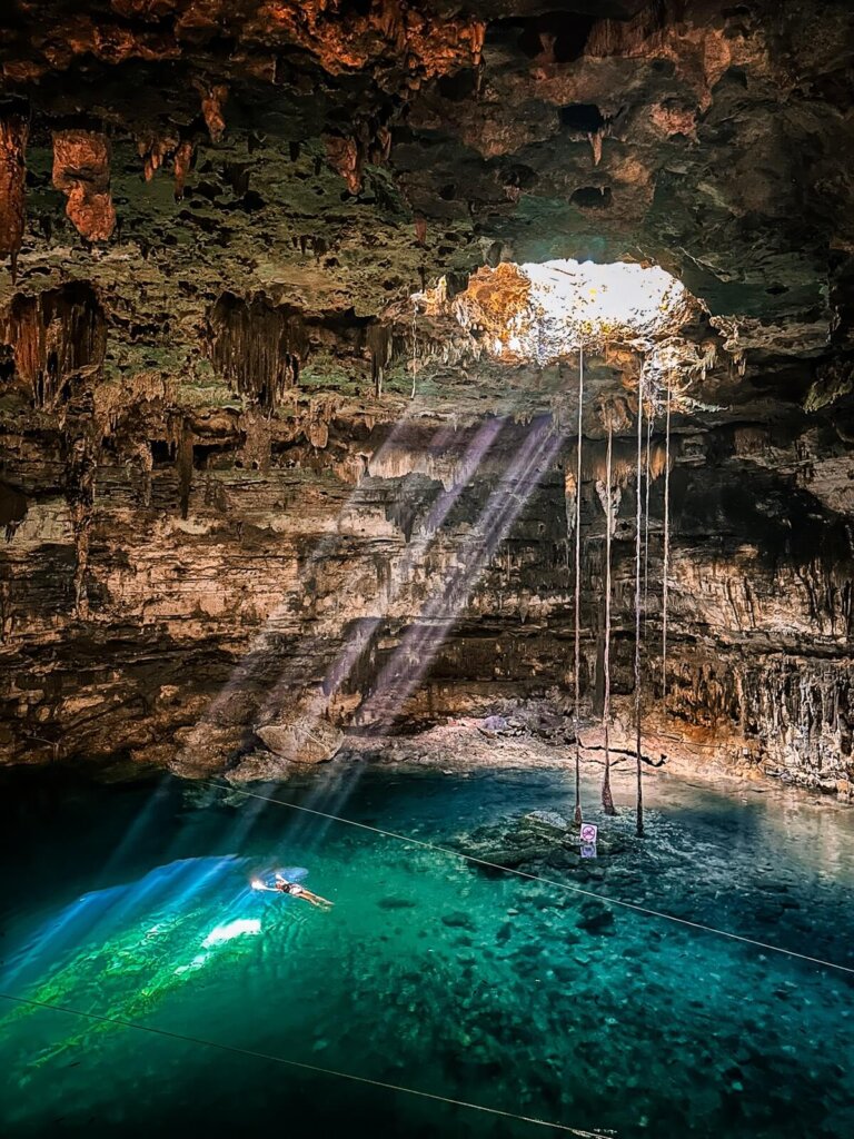 Sunray coming through the ceiling hole of a cenote in Mexico